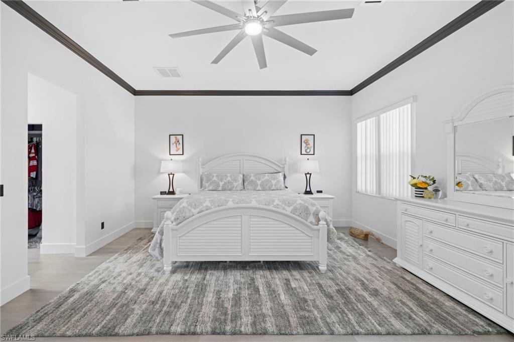 6903 Mauna Loa Lane Naples, FL 34113 - Photo 24 of 46 a bedroom with a bed and a window