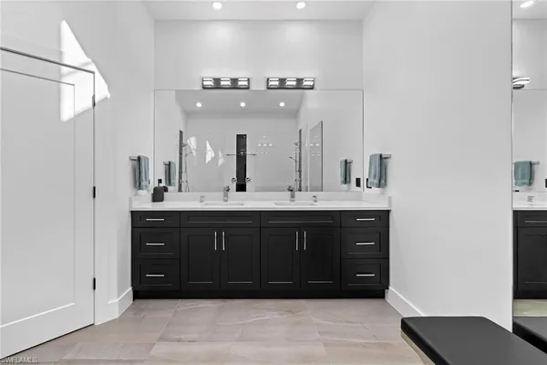 a bathroom with a sink vanity and a mirror