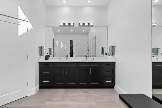 a bathroom with a sink vanity and a mirror