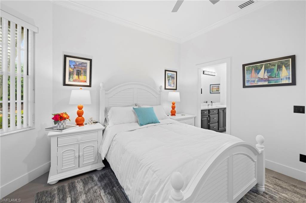 6903 Mauna Loa Lane Naples, FL 34113 - Photo 31 of 46 a bedroom with a bed and a cabinets