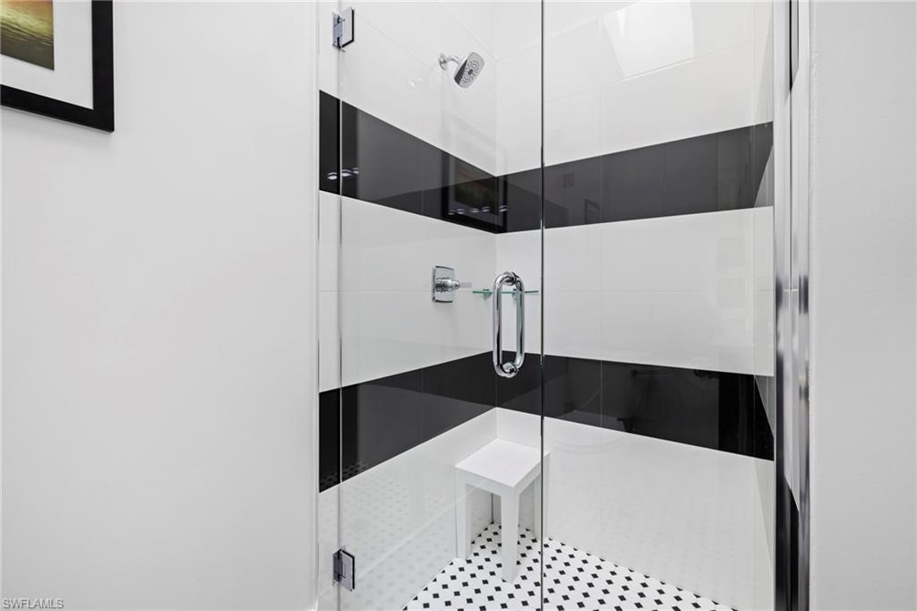 6903 Mauna Loa Lane Naples, FL 34113 - Photo 33 of 46 a bathroom with a bathtub and a shower