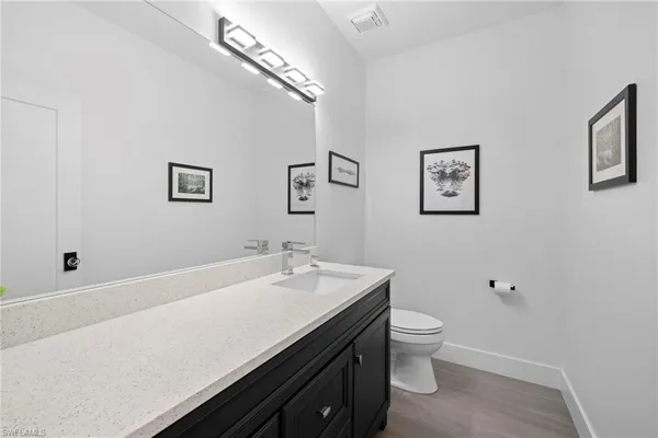 a bathroom with a sink a toilet and mirror