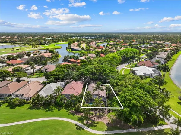 an aerial view of residential houses with outdoor space and street view