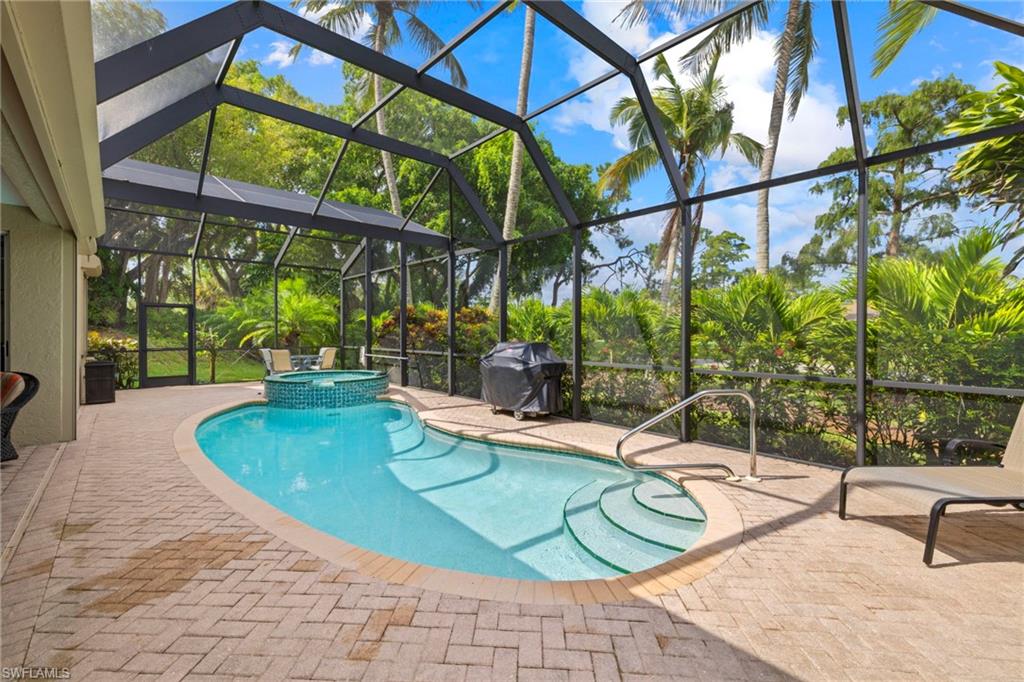 6903 Mauna Loa Lane Naples, FL 34113 - Photo 4 of 46 a view of a swimming pool with a patio
