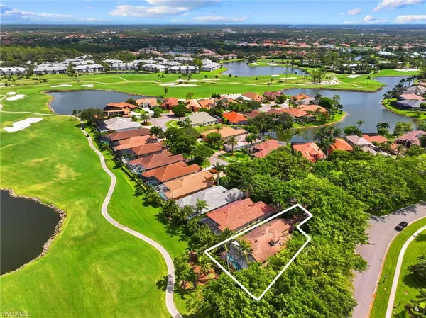 an aerial view of a house with a garden and lake view