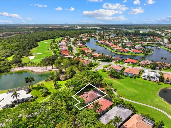 an aerial view of residential houses with outdoor space and lake view