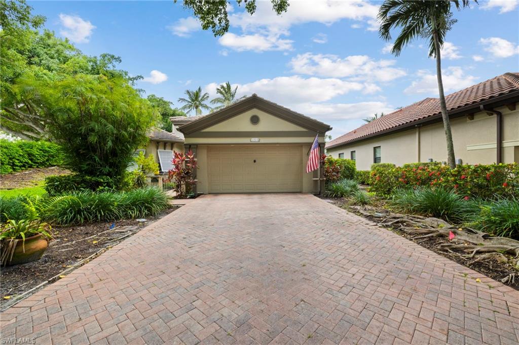 6903 Mauna Loa Lane Naples, FL 34113 - Photo 8 of 46 a front view of a house with a garden