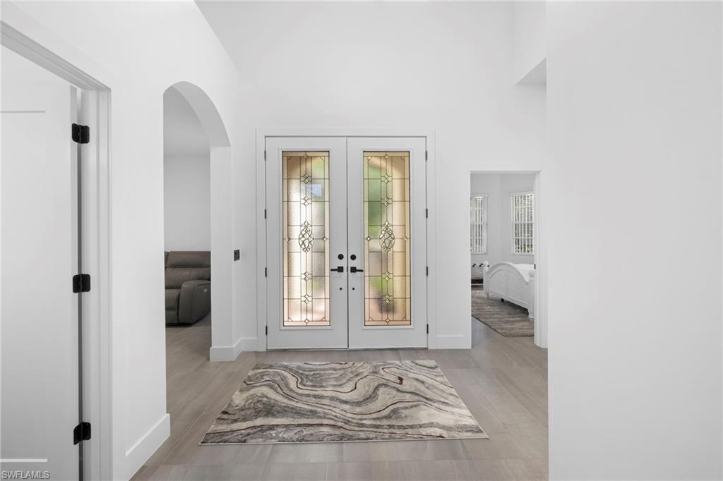 6903 Mauna Loa Lane Naples, FL 34113 - Photo 9 of 46 a view of a room that has a bed in it