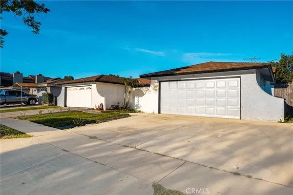 a view of a house with a yard and garage
