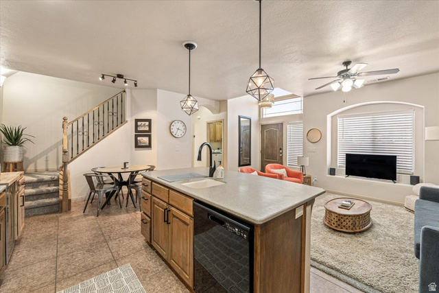 345 North 2450th Street East, Unit 152 St. George, UT 84790 - Photo 40 of 40 Kitchen with open floor plan, black dishwasher, a center island with sink, a ceiling fan, and rail lighting