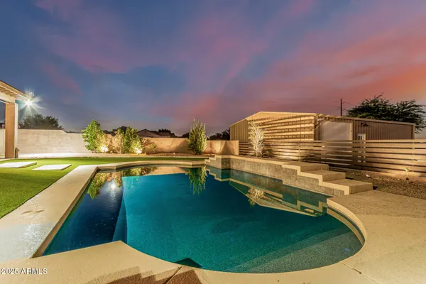 a view of a swimming pool with outdoor seating and plants
