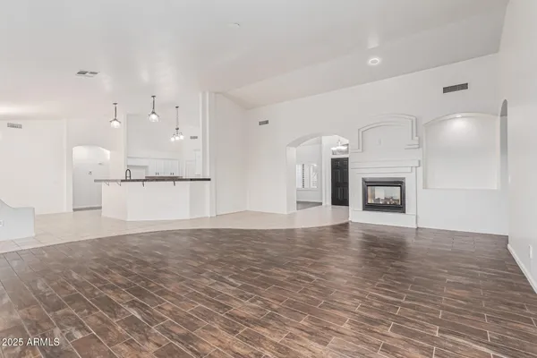 a view of a kitchen with a sink and a fireplace