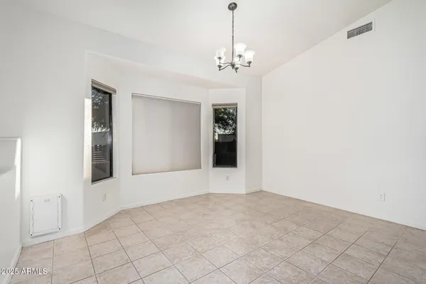 a view of an empty room with chandelier