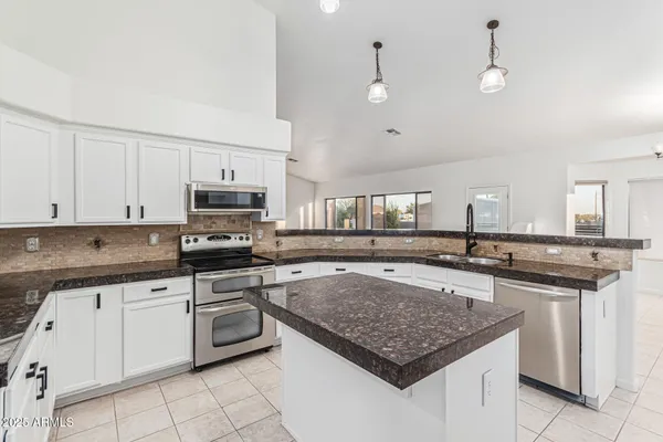 a kitchen with a stove a sink and a refrigerator
