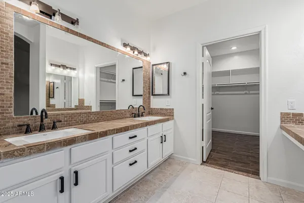 a bathroom with a granite countertop sink mirror and