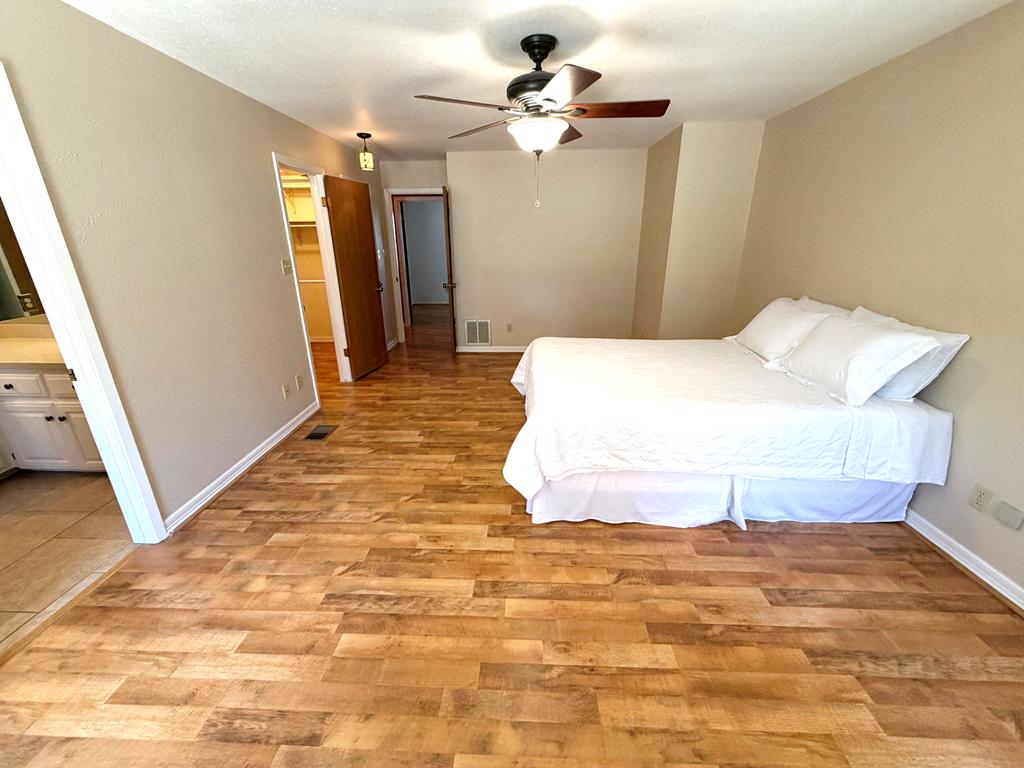 707 Rimrock Road Kerrville, TX 78028 - Photo 27 of 55 a bedroom with a bed and a walk in closet