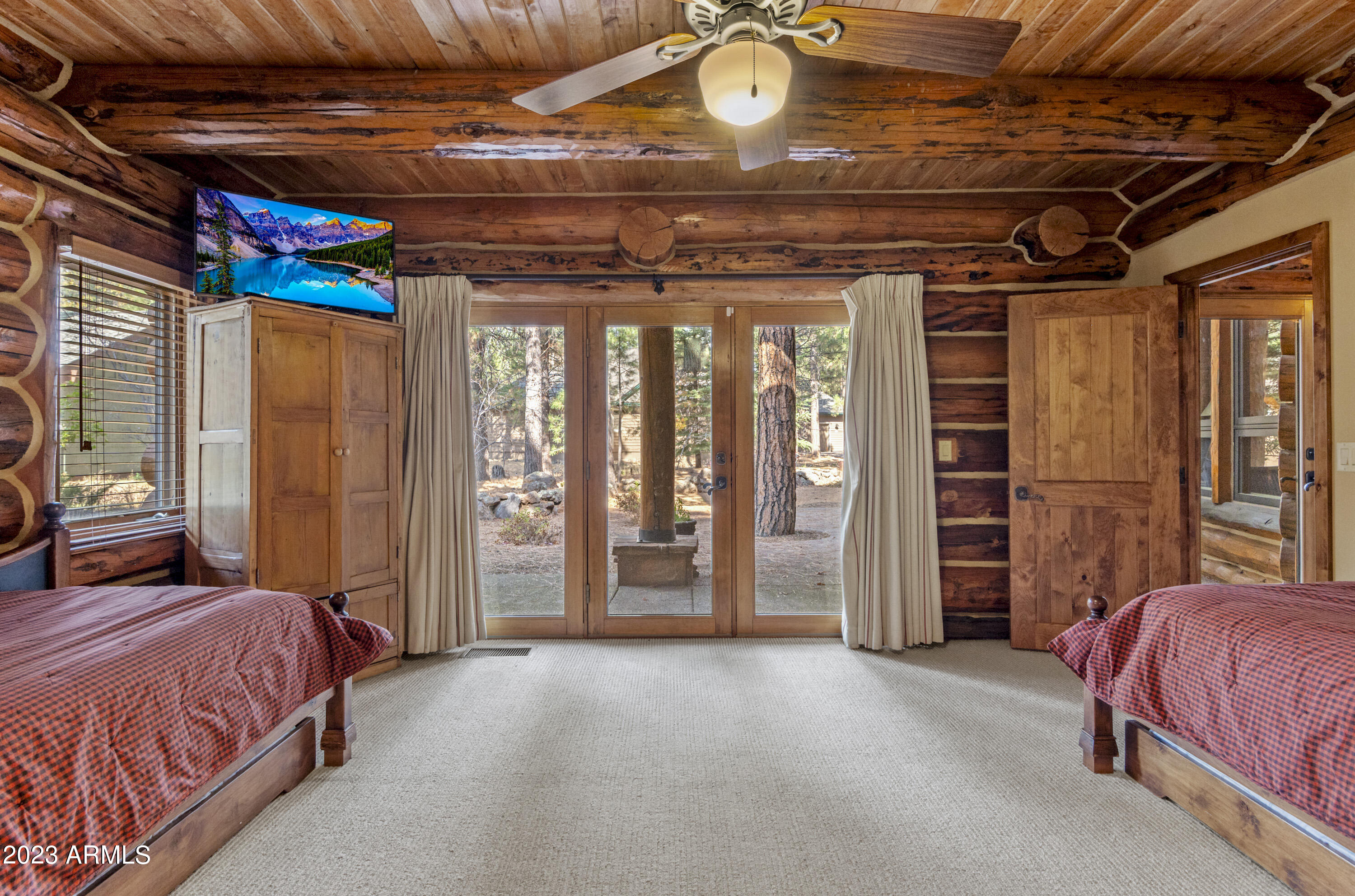 3905 Doc Raymond Flagstaff, AZ 86005 - Photo 32 of 43 a spacious bedroom with a bed and a chandelier