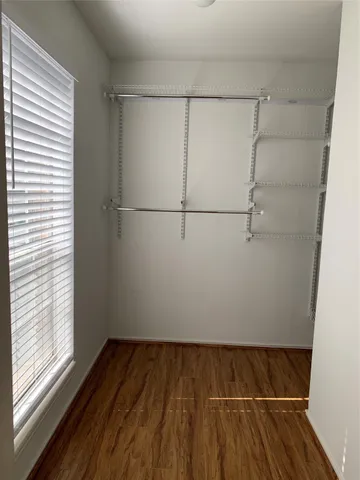a view of a room with wooden floor and white walls