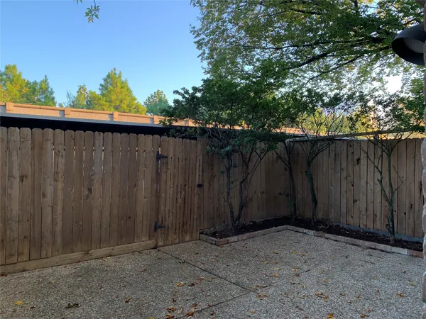a backyard of a house with a tree