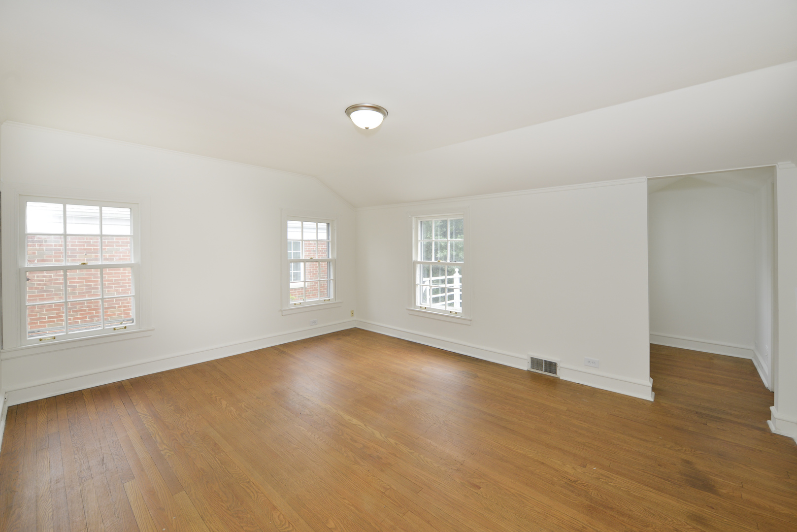 82 Warwick Road Winnetka, IL 60093 - Photo 18 of 24 an empty room with wooden floor and windows