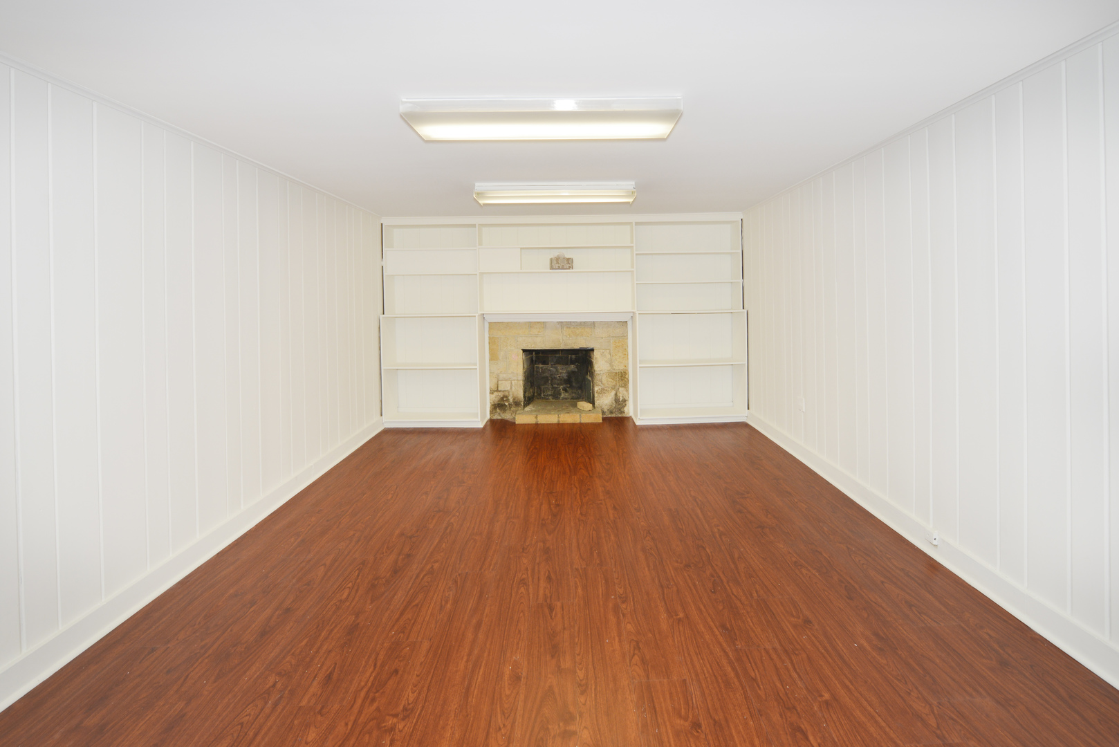 82 Warwick Road Winnetka, IL 60093 - Photo 22 of 24 a view of empty room with wooden floor and fireplace