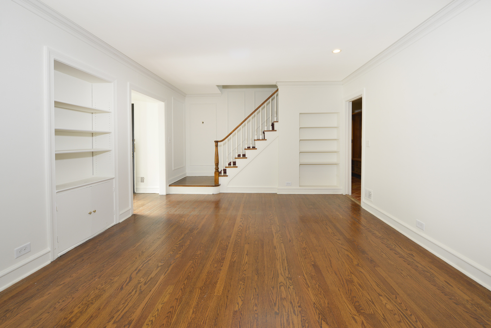 82 Warwick Road Winnetka, IL 60093 - Photo 7 of 24 a view of an empty room with wooden floor and stairs