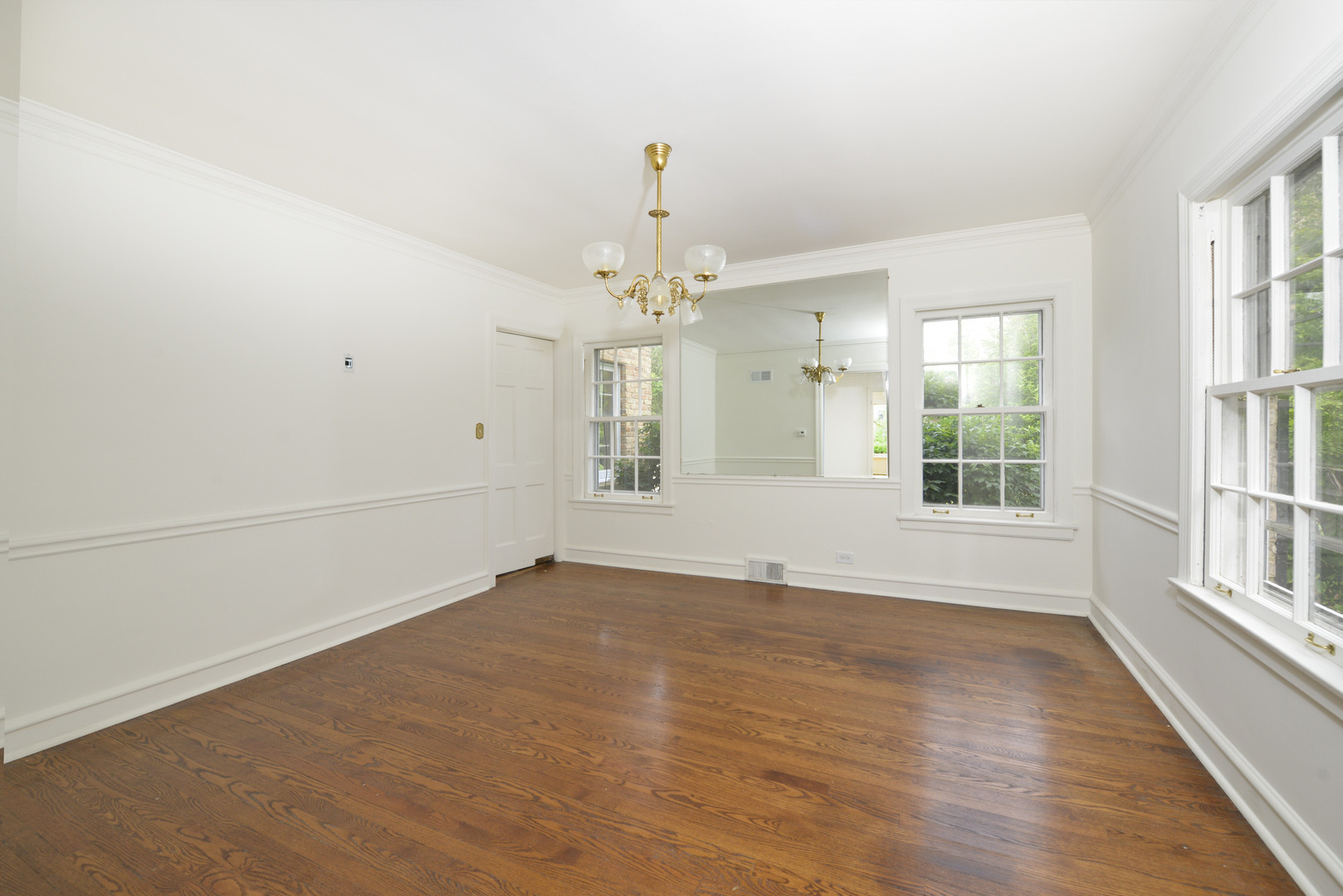 82 Warwick Road Winnetka, IL 60093 - Photo 9 of 24 wooden floor in an empty room with a window