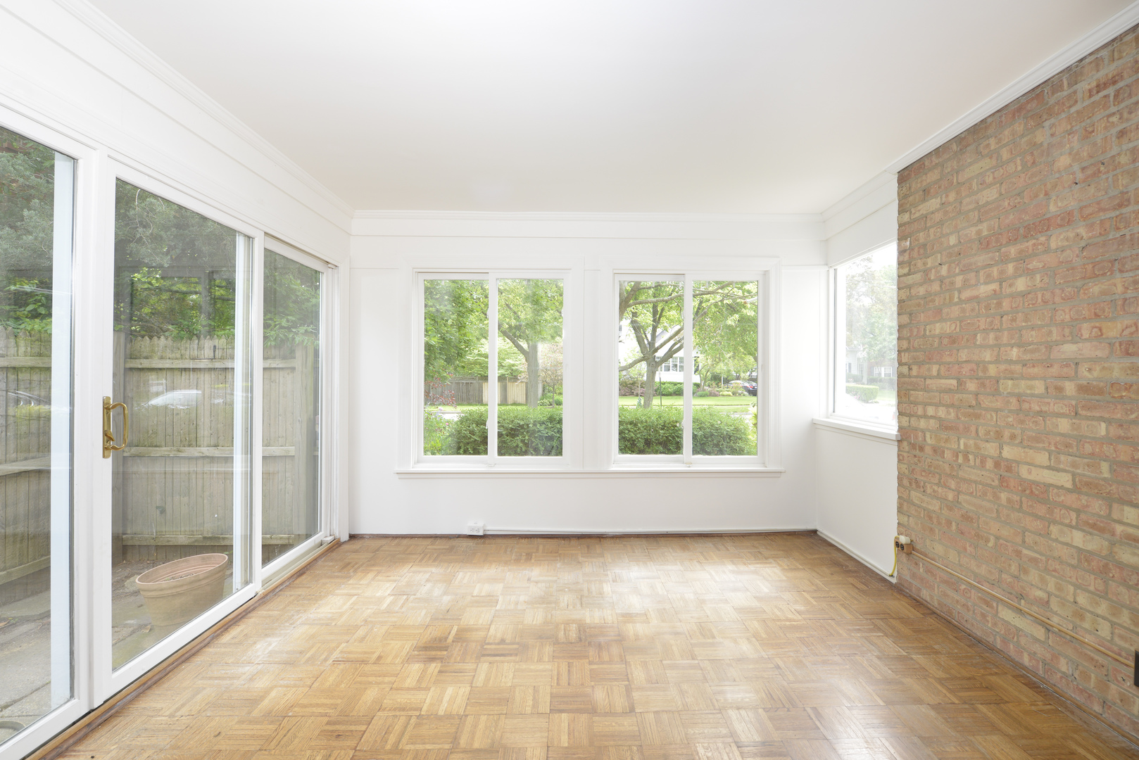 82 Warwick Road Winnetka, IL 60093 - Photo 10 of 24 a view of an empty room with wooden floor and a window