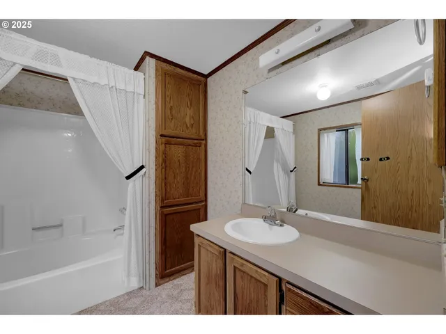 a bathroom with a sink a mirror and a bathtub