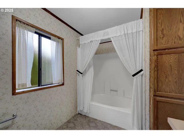 a bathroom with a bathtub and a shower