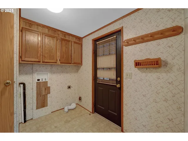 a view of kitchen with granite countertop cabinets and refrigerator