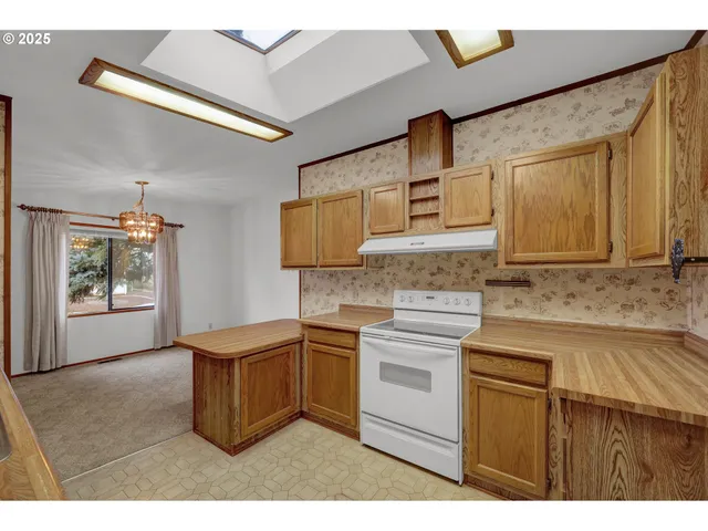 a kitchen with stainless steel appliances granite countertop a sink stove and cabinets