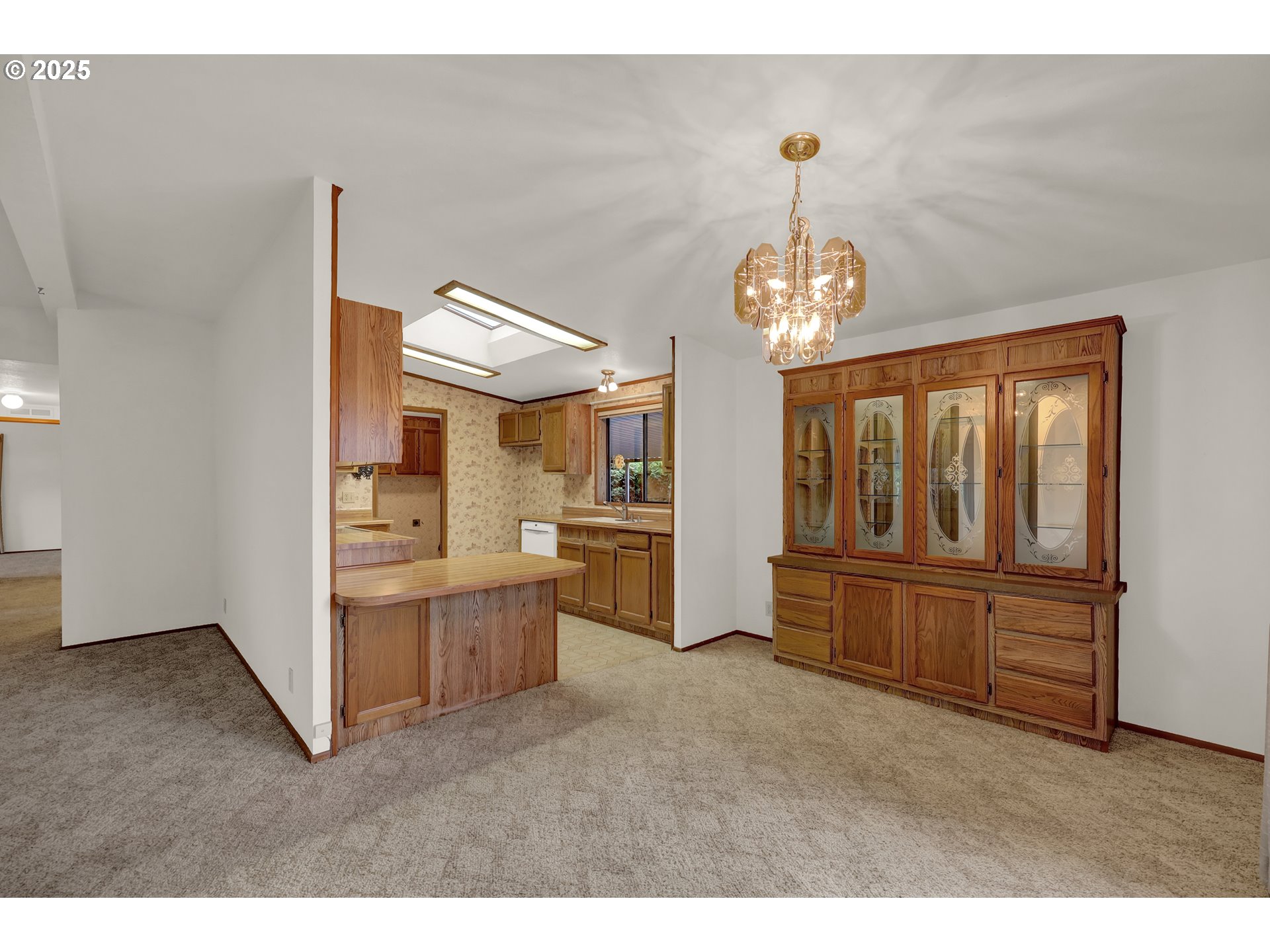 1199 North Terry Street, Unit 366 Eugene, OR 97402 - Photo 6 of 32 a view of a livingroom with furniture cabinet wooden floor and a chandelier