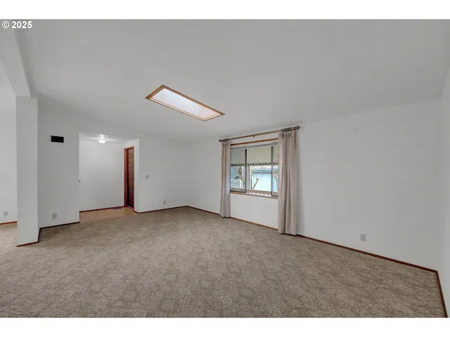 a view of an empty room and a window