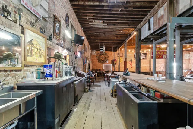 a backyard of a house with plants and tree
