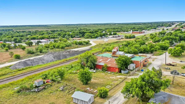 an aerial view of residential houses with outdoor space