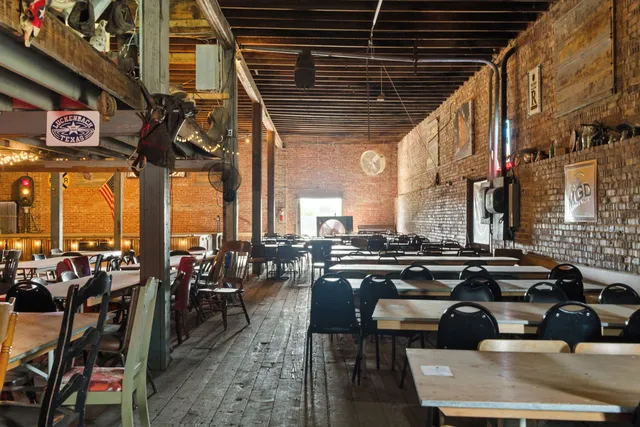 a dining room with furniture and a window
