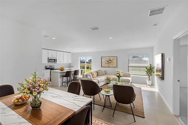 a living room with furniture potted plant and a table