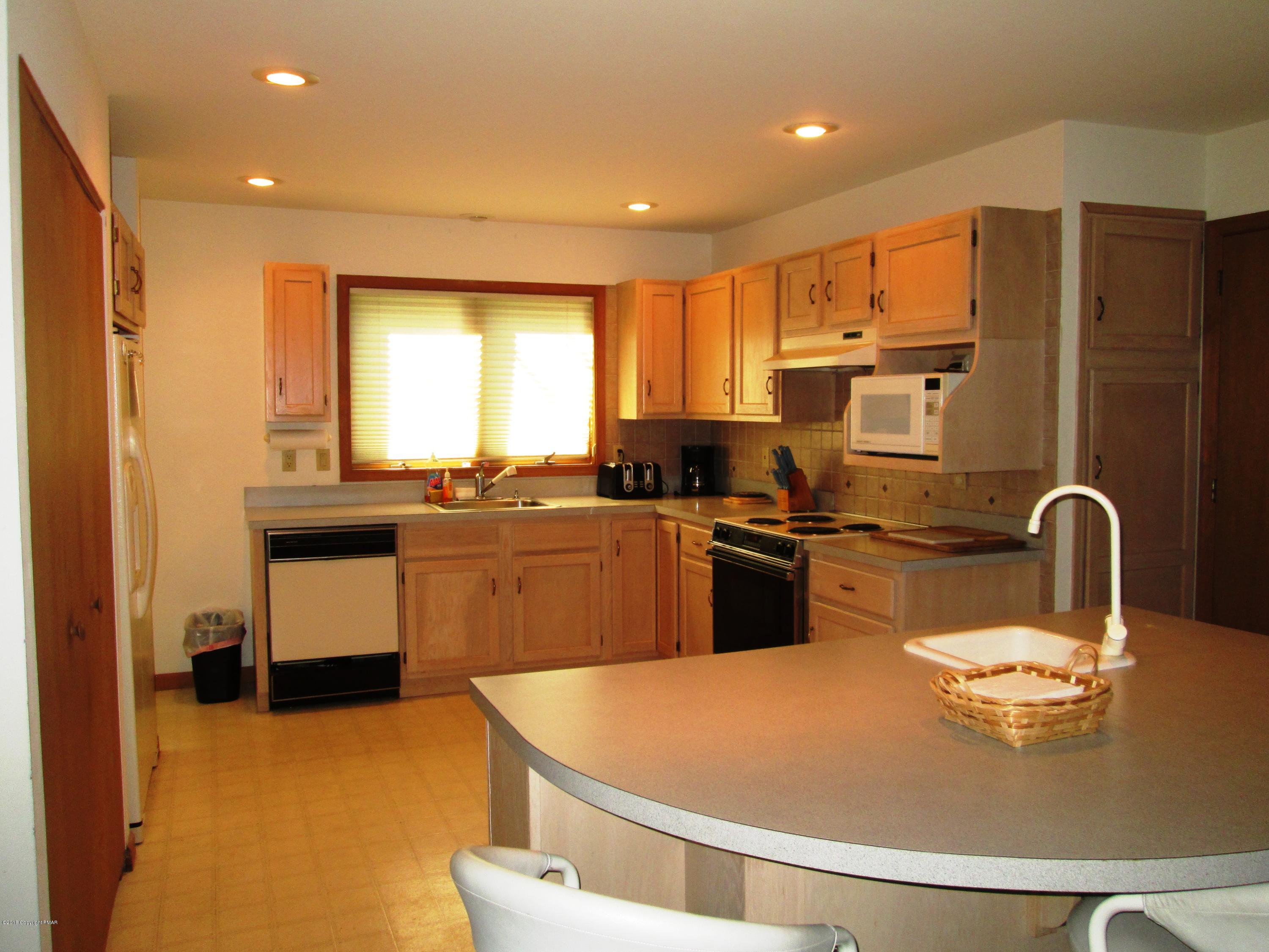 118 Lidio Road Blakeslee, PA 18610 - Photo 11 of 19 a kitchen with stainless steel appliances granite countertop a sink a stove and refrigerator