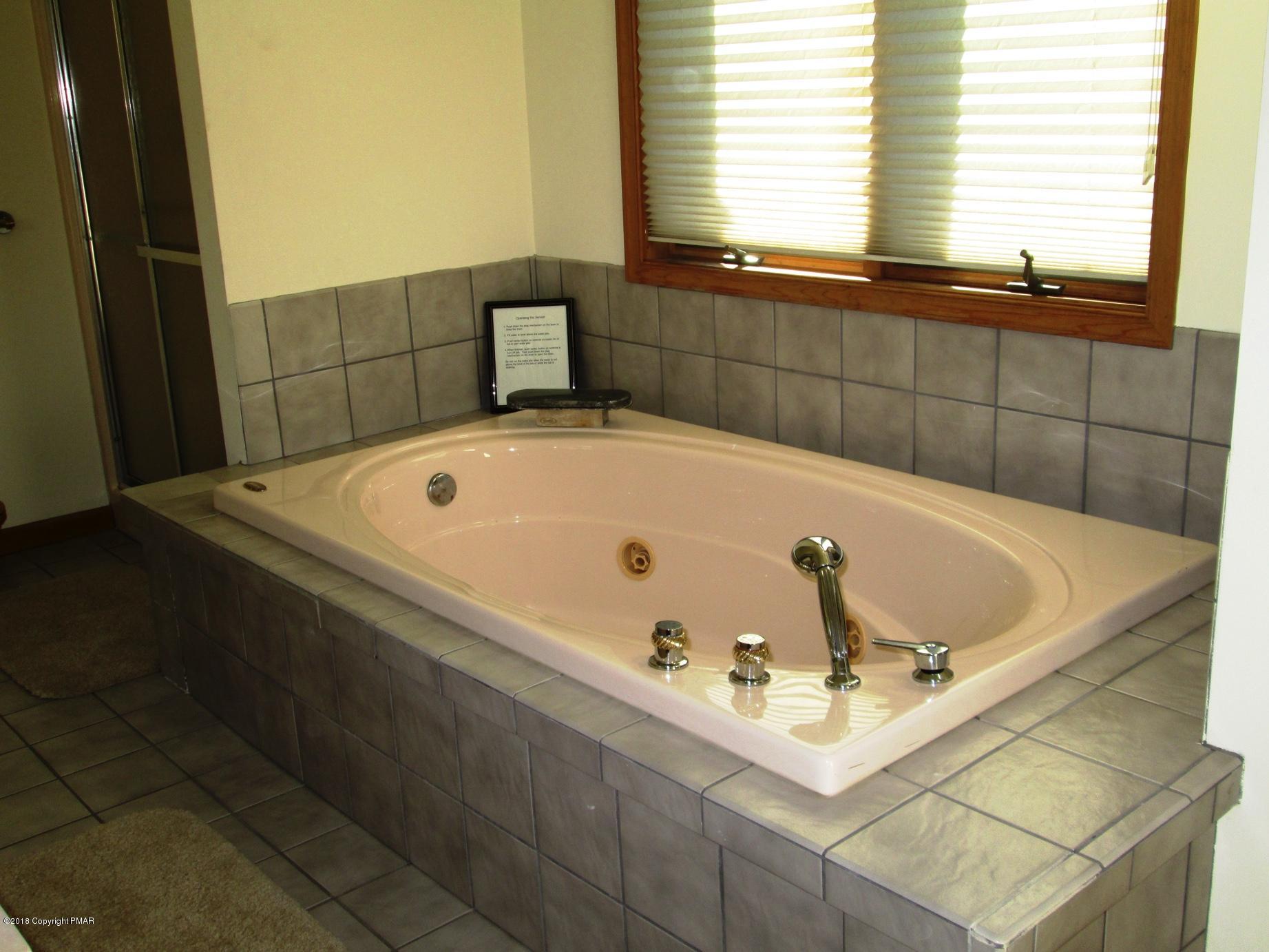 118 Lidio Road Blakeslee, PA 18610 - Photo 14 of 19 a bathroom with a tub and a window