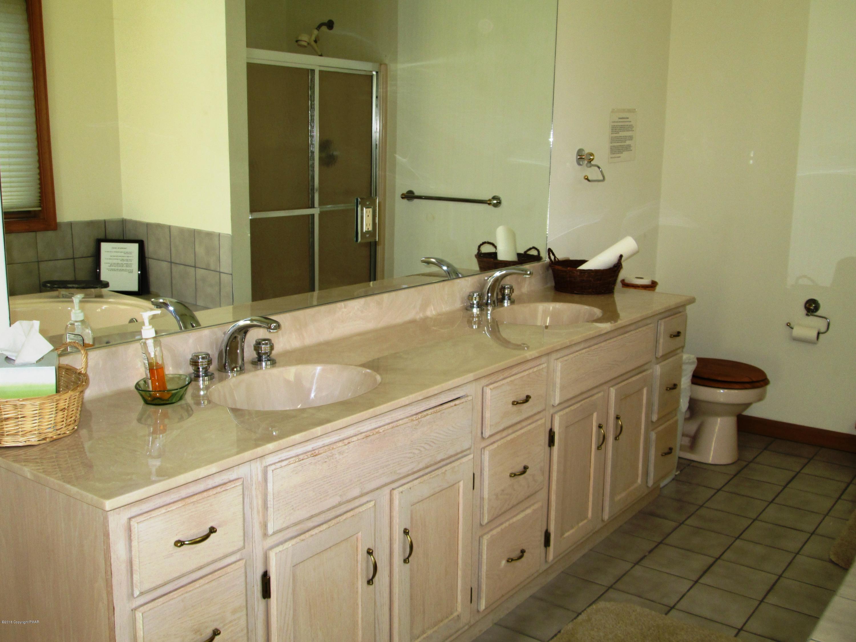 118 Lidio Road Blakeslee, PA 18610 - Photo 8 of 19 a bathroom with a granite countertop sink and a toilet