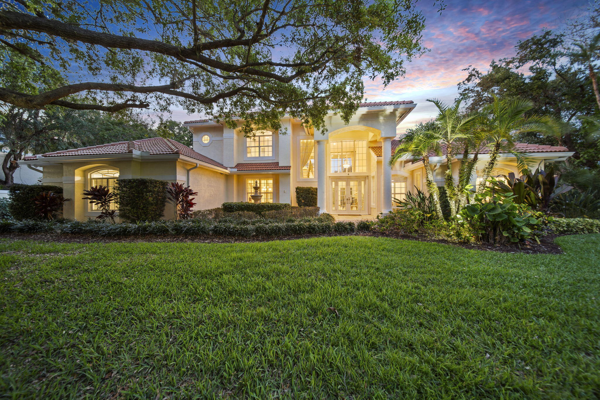 4 Castle Hill Way Stuart, FL 34996 - Photo 3 of 52 a front view of a house with a yard