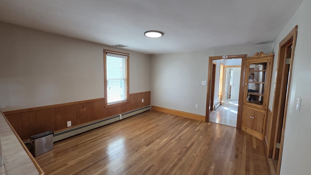 63 Carroll Street, Unit 2 Chelsea, MA 02150 - Photo 13 of 19 an empty room with wooden floor and windows