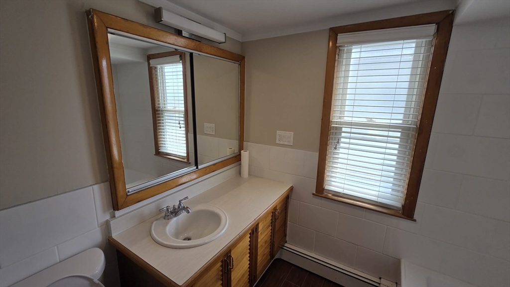 63 Carroll Street, Unit 2 Chelsea, MA 02150 - Photo 16 of 19 a bathroom with a sink a vanity and a window