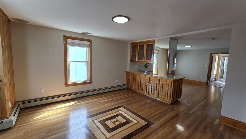 63 Carroll Street, Unit 2 Chelsea, MA 02150 - Photo 4 of 19 wooden floor in an empty room with a window