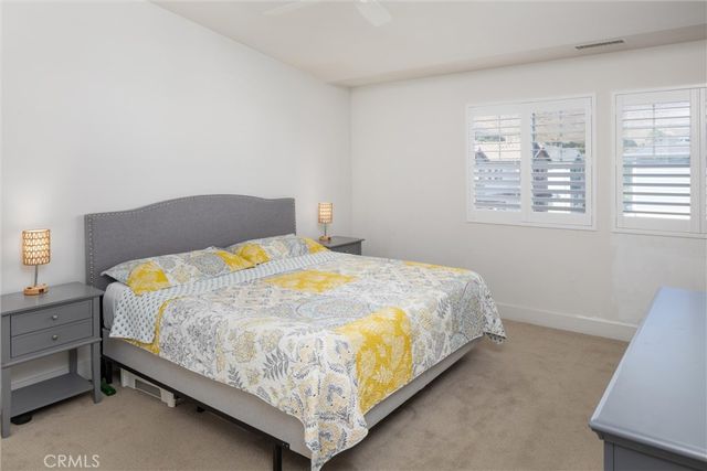 a bed sitting in a bedroom next to a window