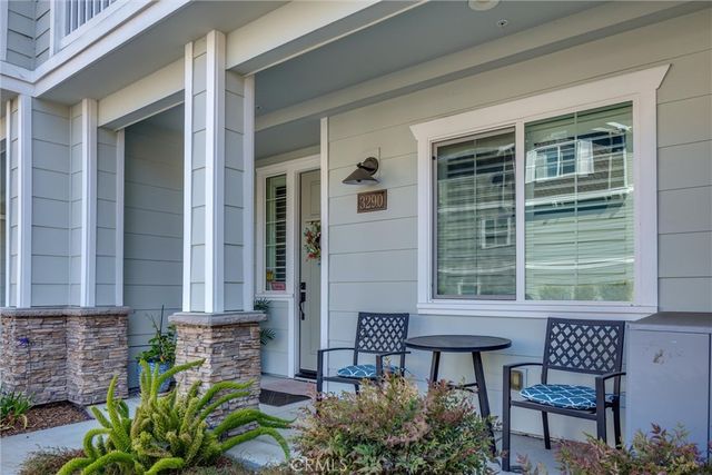 a view of a house with backyard and sitting area