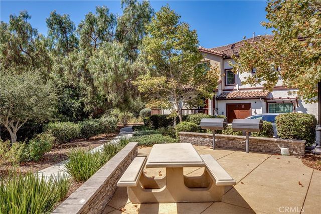 a view of a patio with table and chairs and potted plants