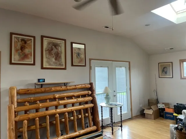 a bedroom with a bed and wooden floor