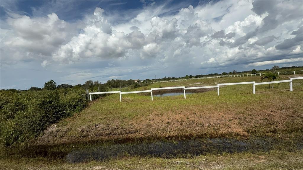 20375 Northwest 248th Street Okeechobee, FL 34972 - Photo 2 of 2 a view of a lake with houses in the back